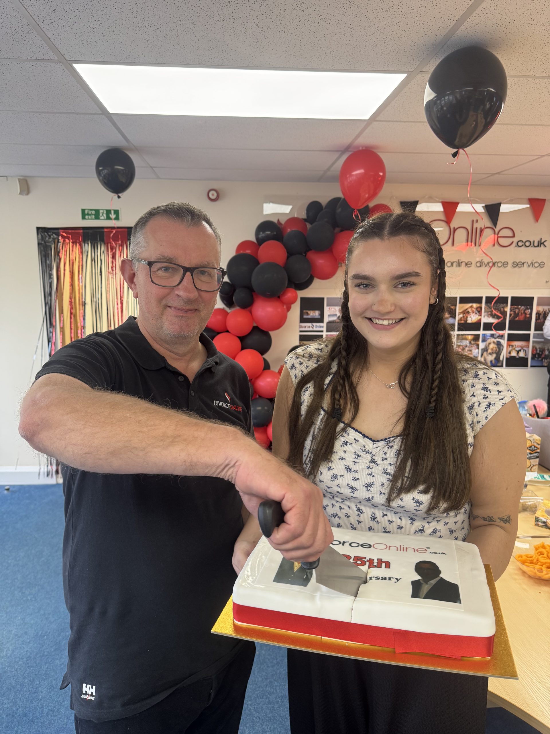 Image of Mark Keenan and Olivia Keenan who work at divorce-online.co.uk cutting a cake